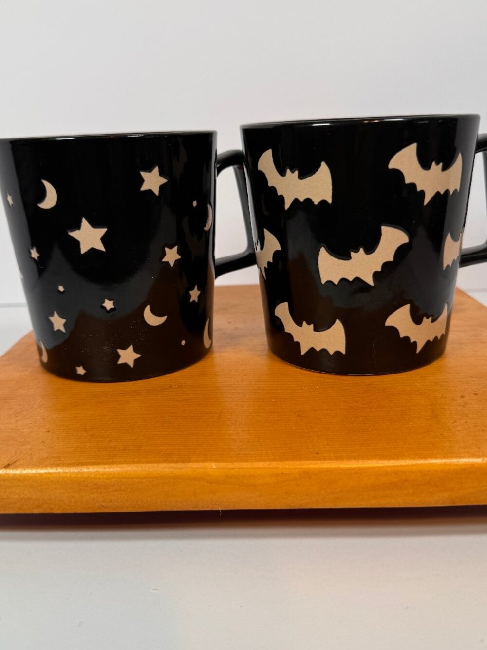 Coffee Mug Black ceramic, one with flying bats and the other with stars and moon